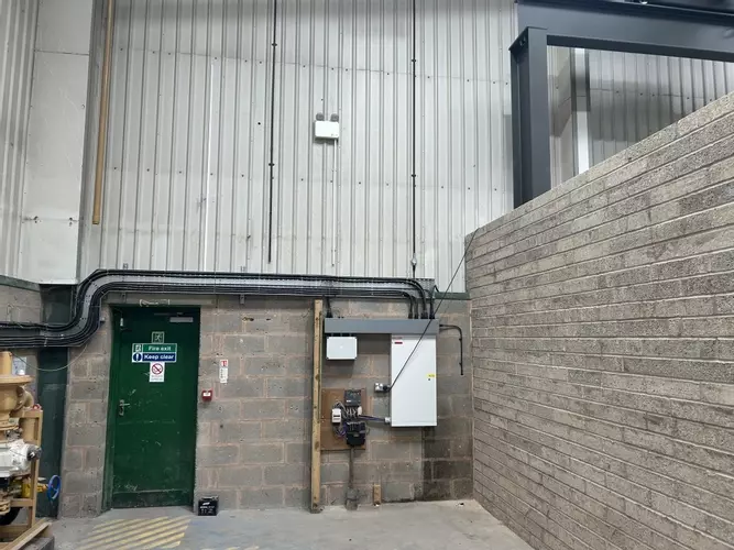 Part of the new pipework infrastructure installed at the Tamworth facility. This section shows three stacked pipework runs routed through the building &mdash; two high-pressure lines supplying the wash bay and one low-pressure feed serving the pressure washin